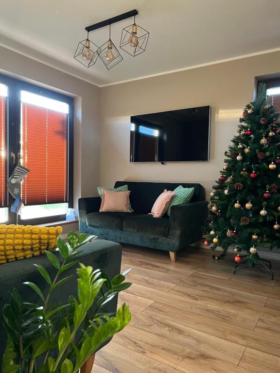 a living room with a christmas tree and a couch at Spithamn Village House in Spithami