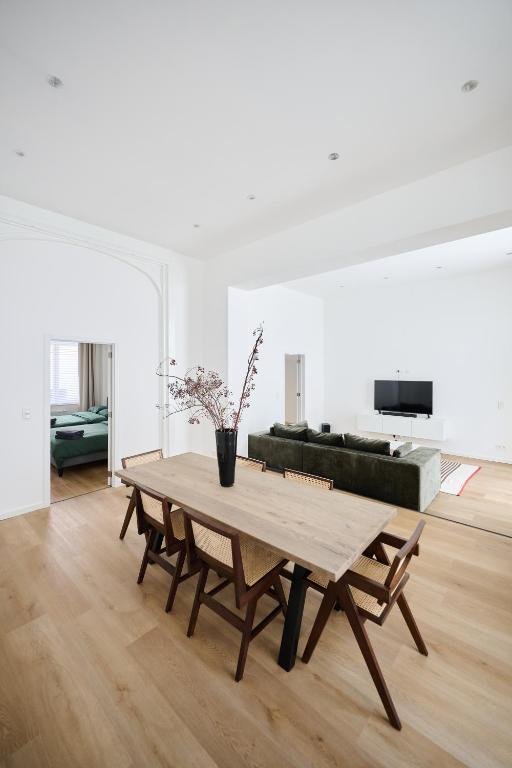 a living room with a wooden table and a couch at Toison d'Or & saunna 2 in Brussels