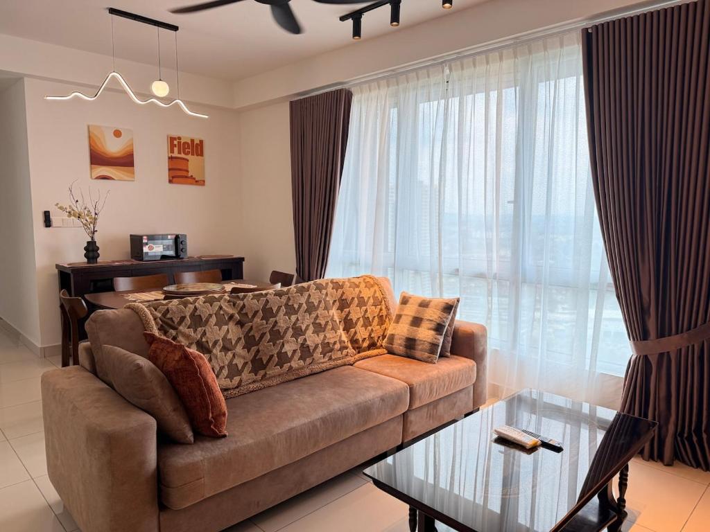 a living room with a couch and a table at Self Check in at Classy 3BR Kajang in Kajang