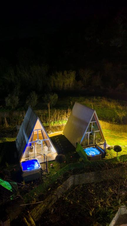 a couple of tents sitting in a field at night at Alex's House Shirokë in Shkodër