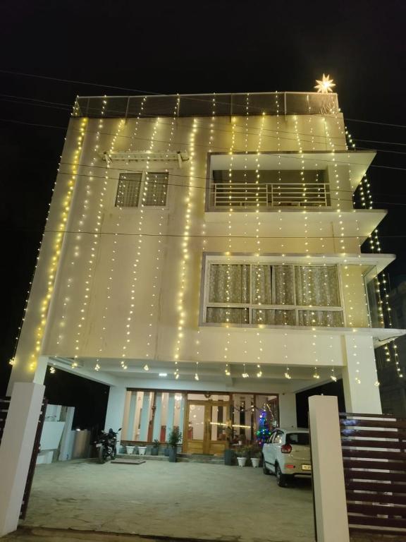 a large white building with lights on it at D'Bonn Inn in Shillong