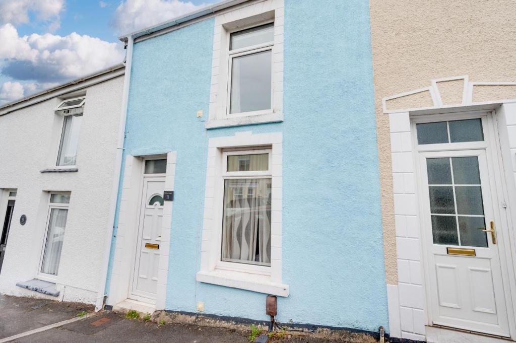 a blue house with white doors on a street at 3 Bed in Mumbles oc-hh668 in The Mumbles