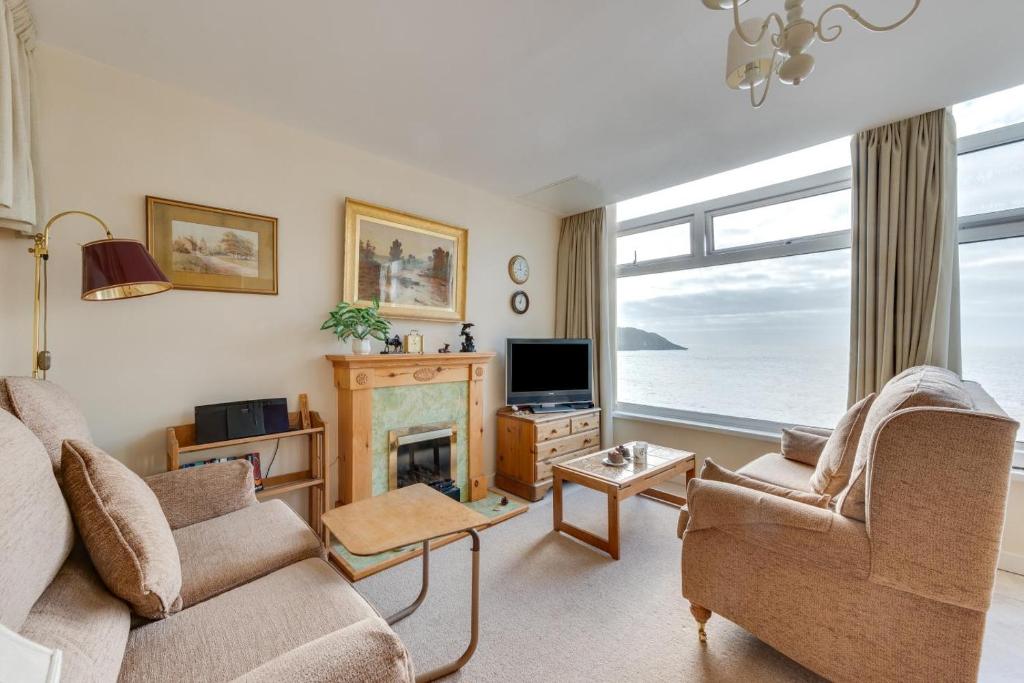 a living room with a fireplace and a television at 2 Bed in Gower oc-hh919 in Bishopston