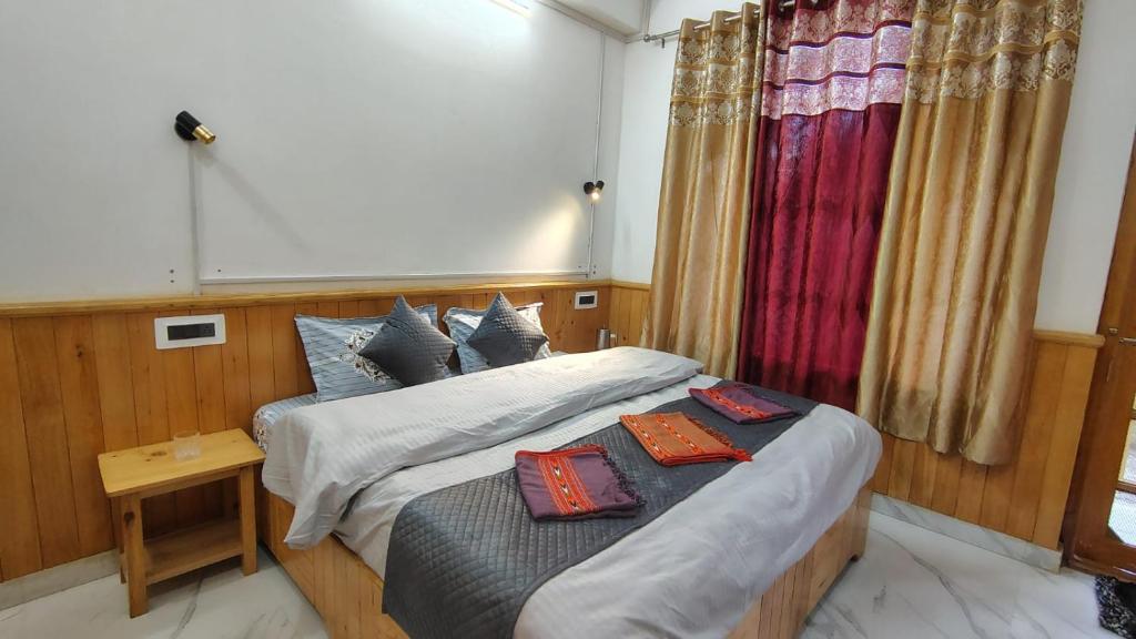 a bedroom with a bed with two pillows on it at Rana Ridges in Banjār