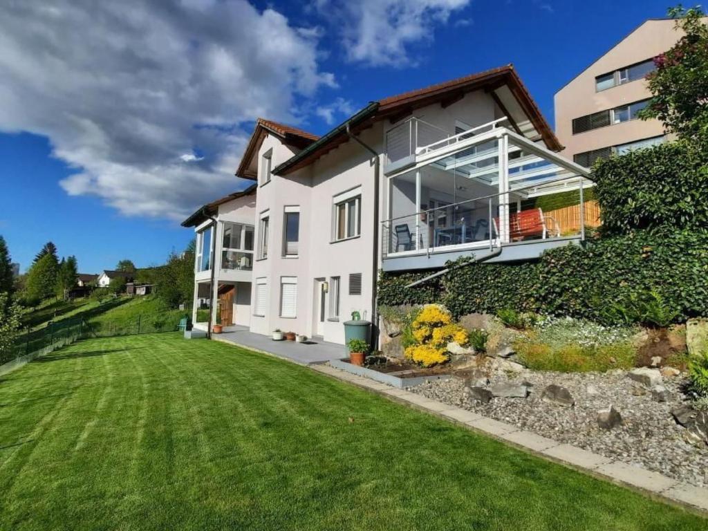 a large white house with a green yard at Apartment Angenweg 2 by Interhome in Entlebuch