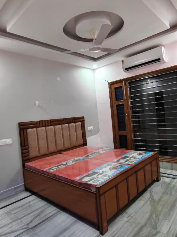 a bed in a room with a ceiling fan at Homestay Mohali in Chandigarh Airport