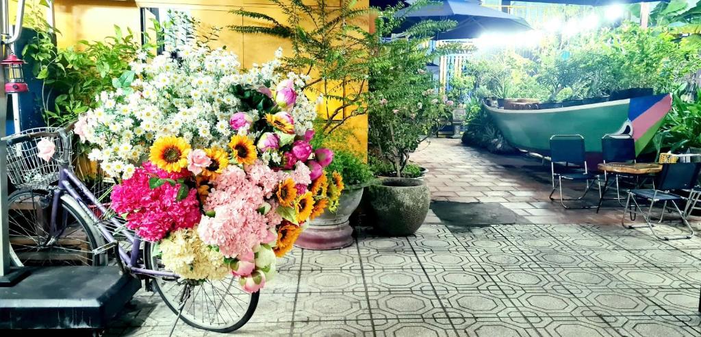 a bike with a bunch of flowers on it at Homestay & Camping Phan Thiet Beach in Ấp Bình Hưng