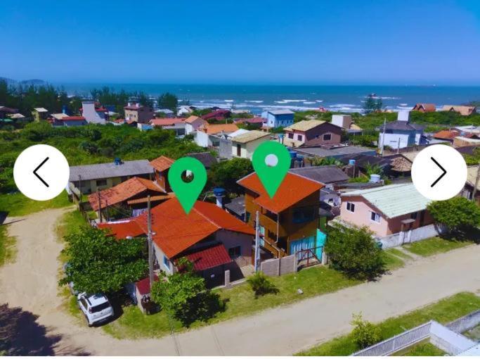 a small town with green signs on top of houses at Riba Brisa in Imbituba