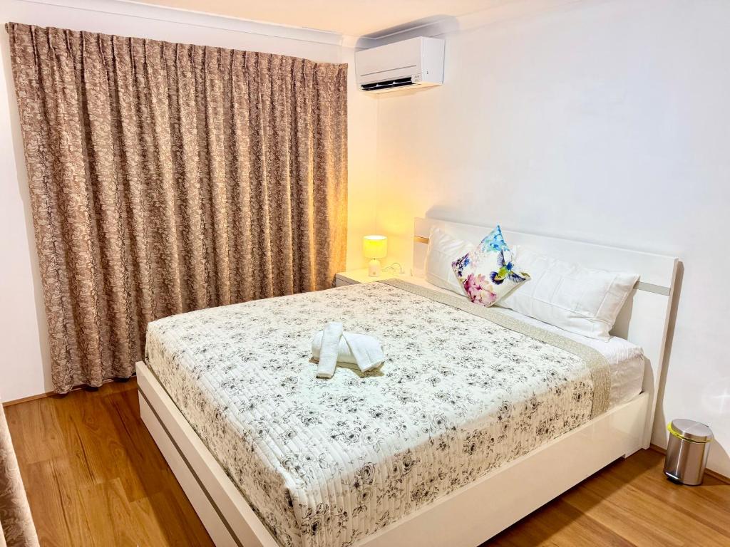 a bedroom with a bed with a teddy bear on it at Affordable accommodation near Perth CBD in Perth