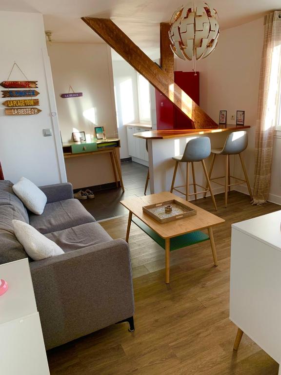 a living room with a couch and a table at Appartement Carnac, Centre bourg - 2 pieces in Carnac