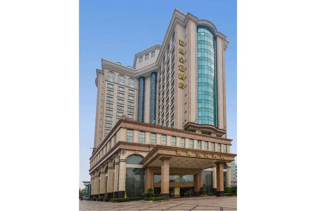 a large building with a sign in front of it at Grand Royal Hotel in Guangzhou