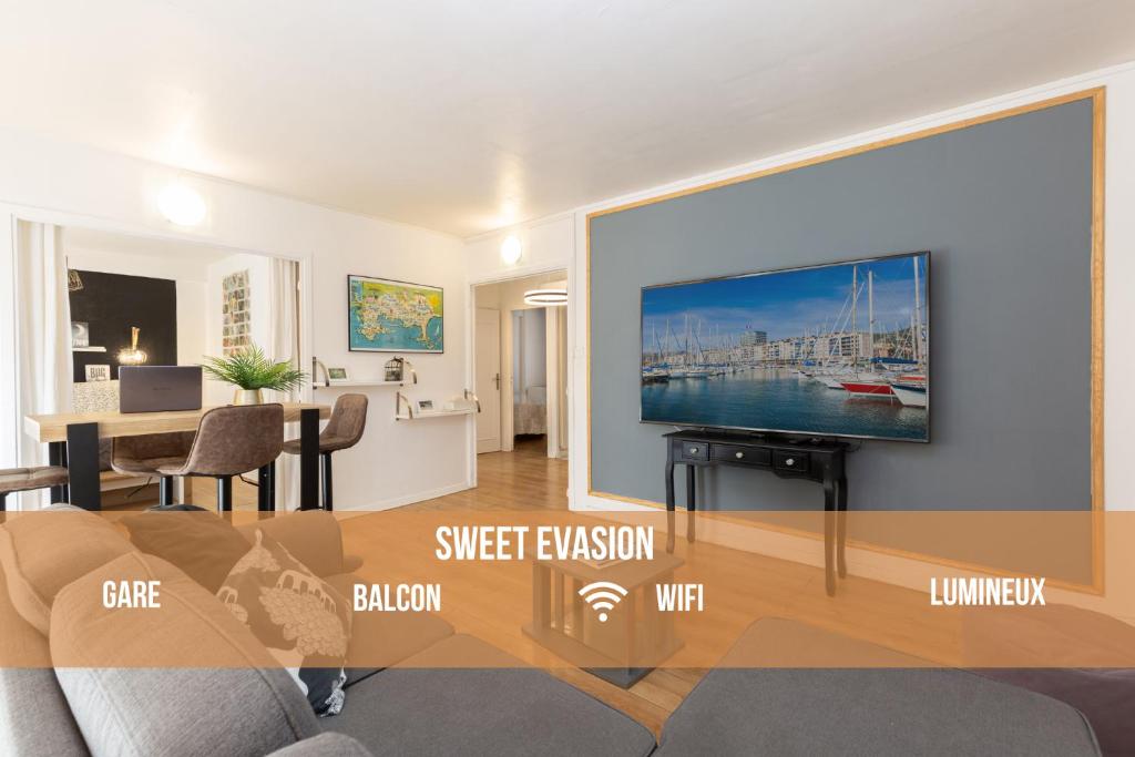 a living room with a flat screen tv on a wall at Sweet Evasion - Wifi - Host Provence in Toulon