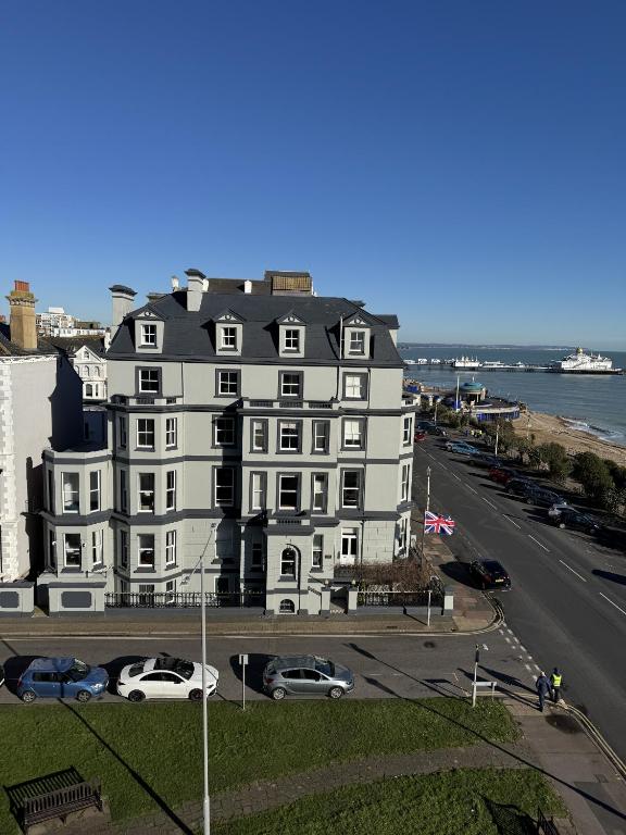 a large white building on the side of a street at West Rocks Hotel in Eastbourne