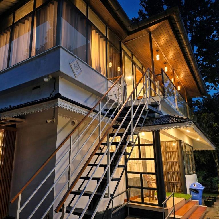 a staircase leading up to a house at Nellar Dream Resort in Meppādi