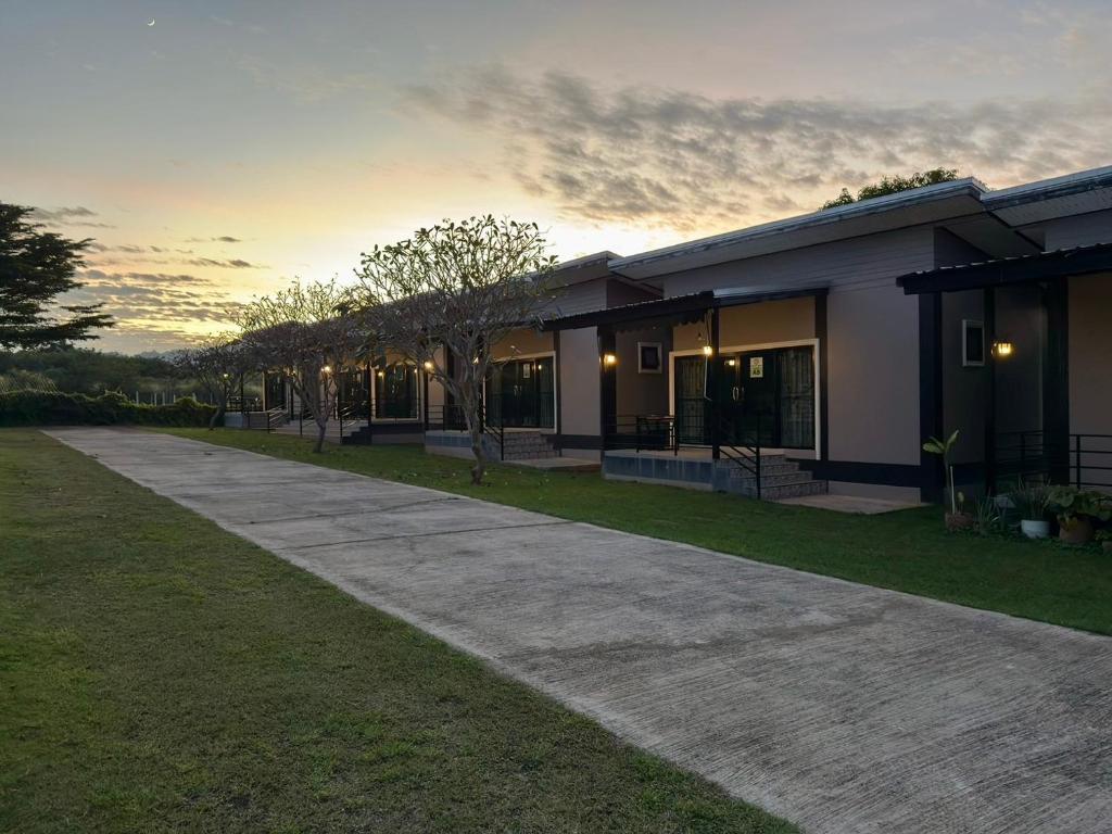 a house with a driveway in front of it at Lek Village Khaoyai in Pak Chong