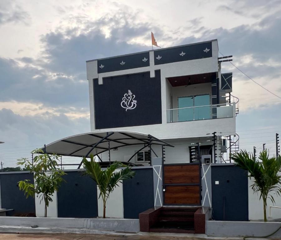 a building with an umbrella in front of it at Next Nest in Gannavaram