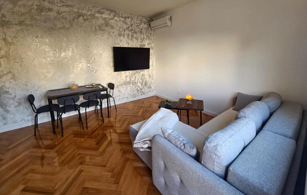 a living room with a couch and a table at Modern Apartment - Capljina Center in Čapljina