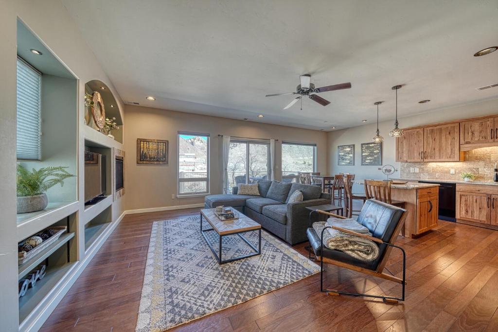 a large living room with a couch and a kitchen at Riverfront Perch, w Balcony over the River in Salida