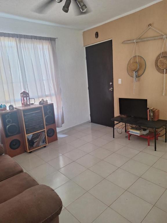 a living room with a couch and a table at Comfortable and nice house in Caucel in Mérida