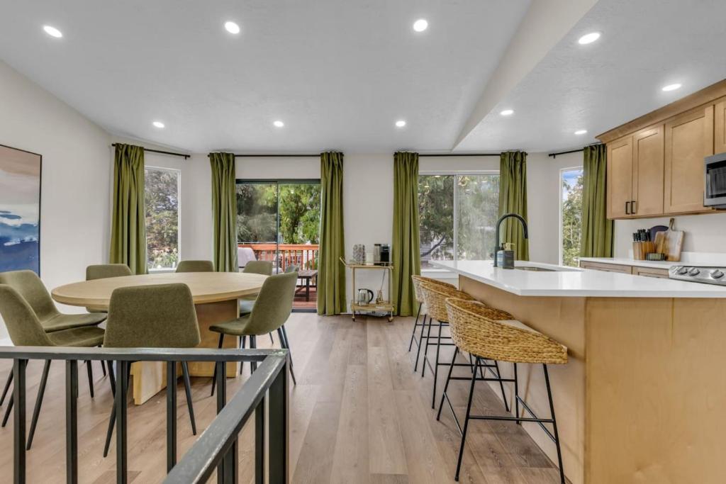 a kitchen and dining room with a table and chairs at Lehi High Luxe Views and Sky in Lehi