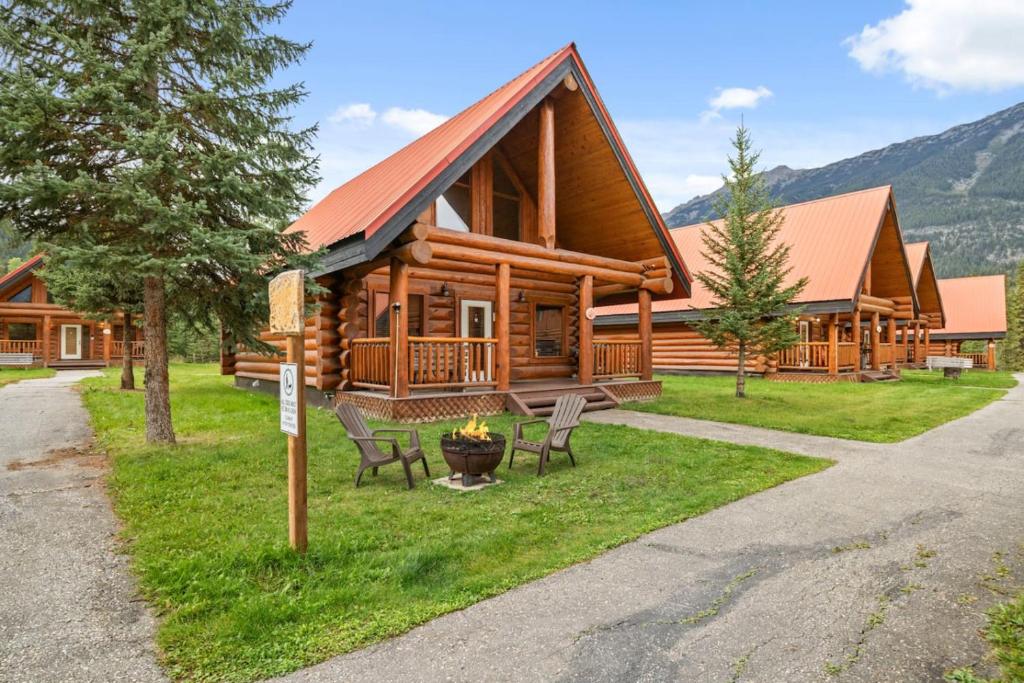 a log cabin with chairs in front of it at Rustic Chalet Perfect Getaway for Groups in Golden