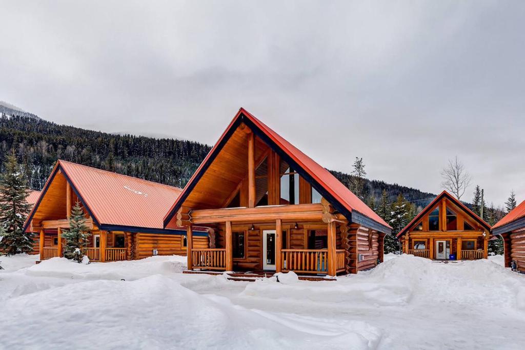 a log cabin with snow on the ground at Authentic, Timber Log Cabin Perfect for Groups in Golden