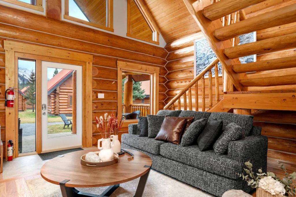 a living room with a couch and a table at Rustic Cabin Hideaway with BBQ Fire Pit and Mtn Views in Golden