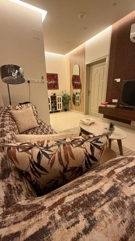a large room with a bed and a table at شقة بطابع أنيق in Al Kharj