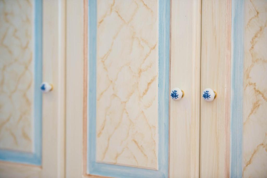 a wooden cabinet with blue doors in a room at Casa Cinque in Positano