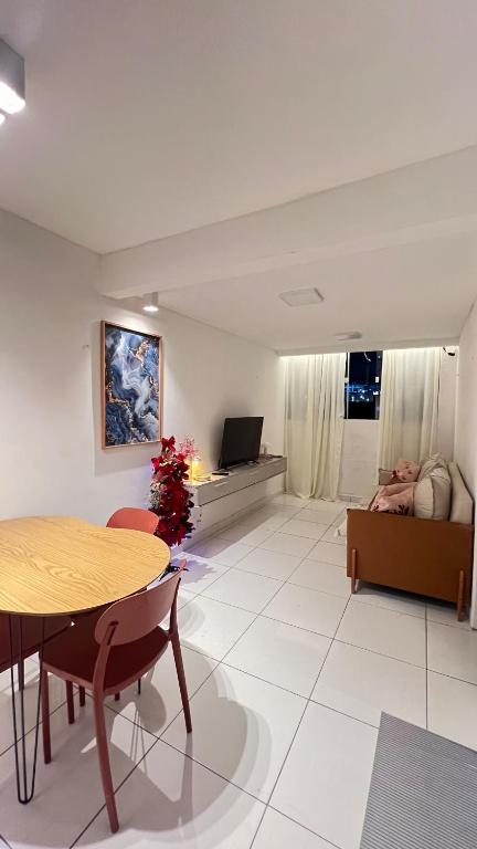 a living room with a table and a couch at Apt 424 in João Pessoa