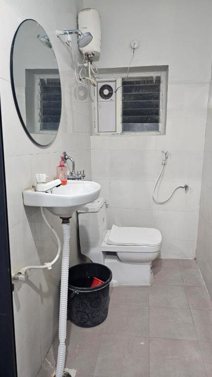 a bathroom with a sink and a toilet and a mirror at THE NEXOS UNIQUE SUITEs in Jāmb