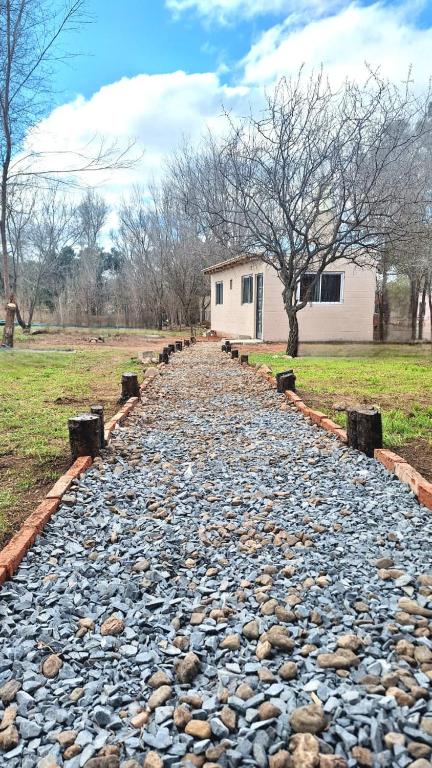 a cobblestone path in front of a house at La Eterna in Villa del Dique