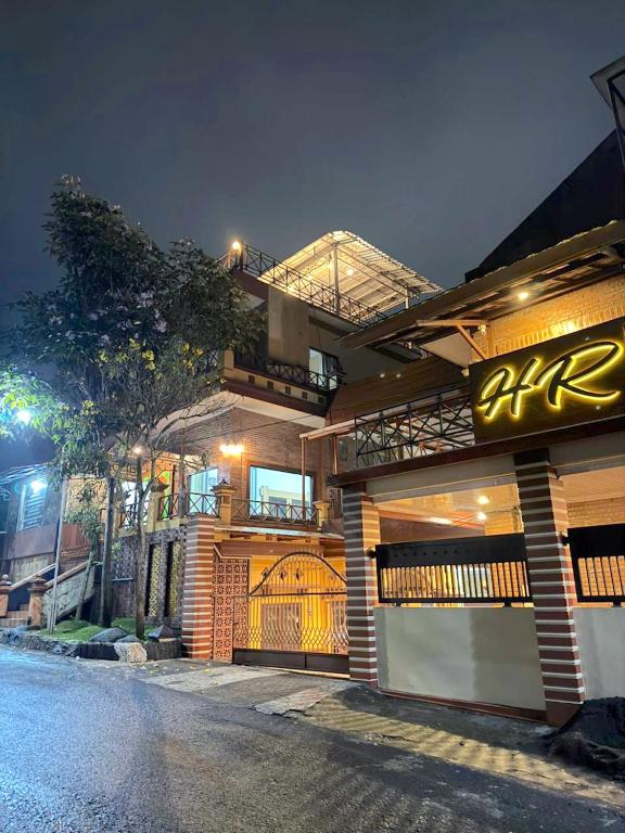 a building with a sign on the side of a street at HR Hotel Batu in Batu
