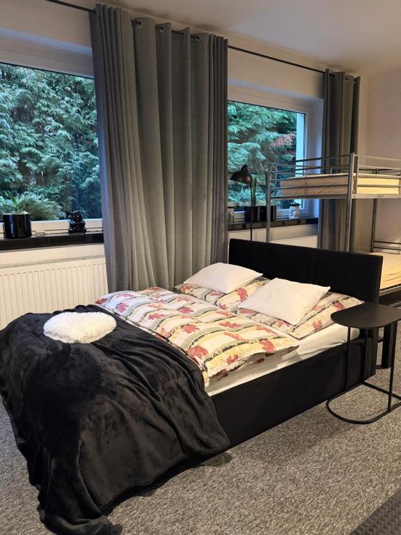 a bed in a room with a window and a bed sidx sidx sidx at Apartament Pod Kukułką in Kłodzko