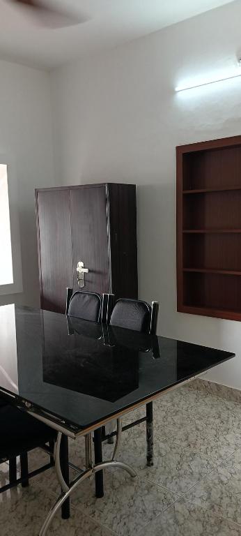 a table with a black counter top in a room at AI cube Homes in Pīrmed