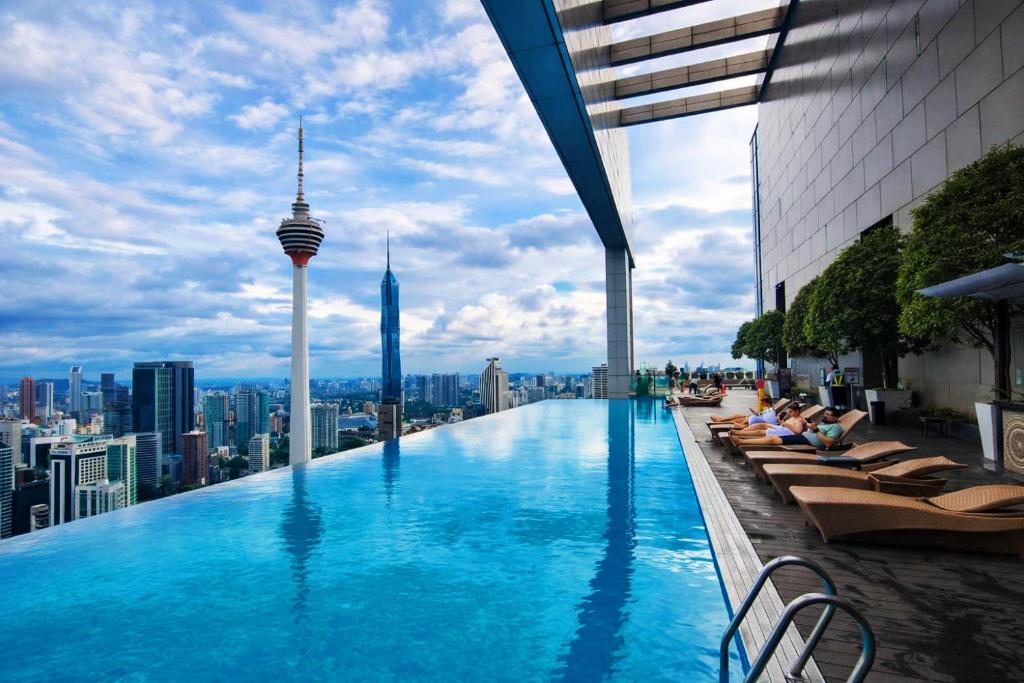 a swimming pool on the roof of a building with a city at The Platinum Kuala Lumpur by MAHA in Kuala Lumpur