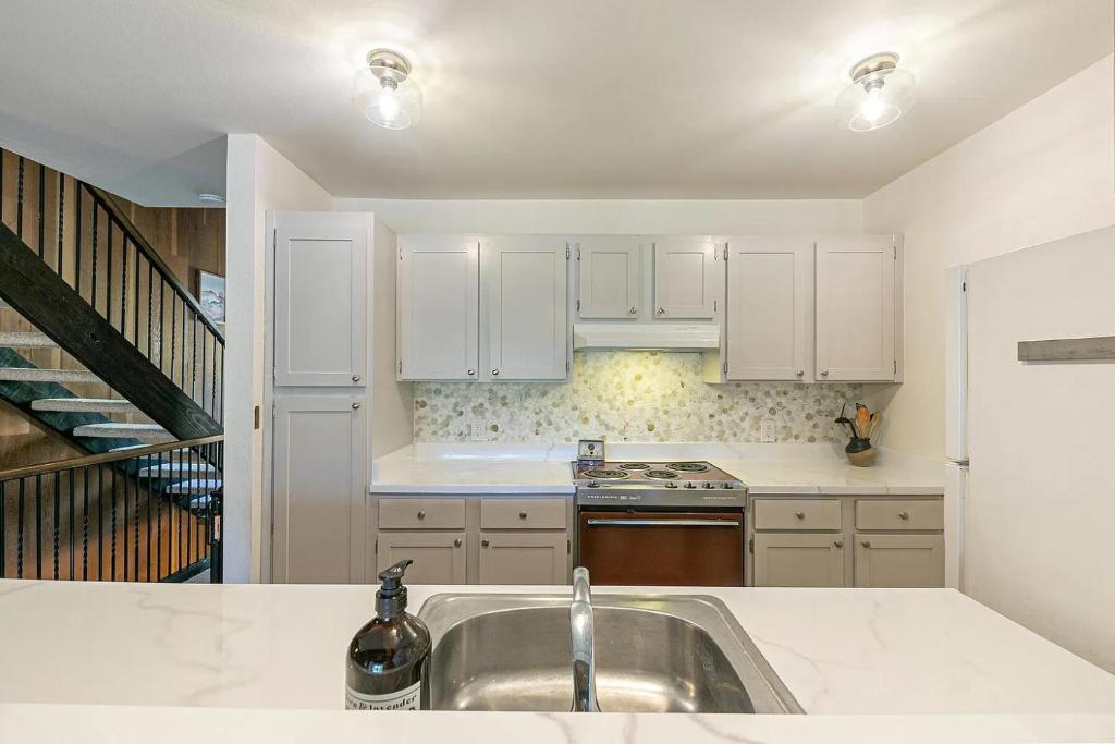 a kitchen with white cabinets and a sink at Kingswood Pines in Kings Beach