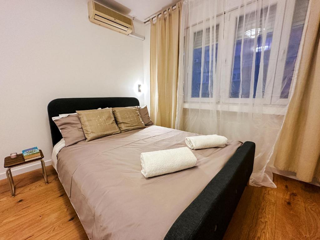 a bed with two pillows on it in a bedroom at Astor Wellness apartman in Belgrade