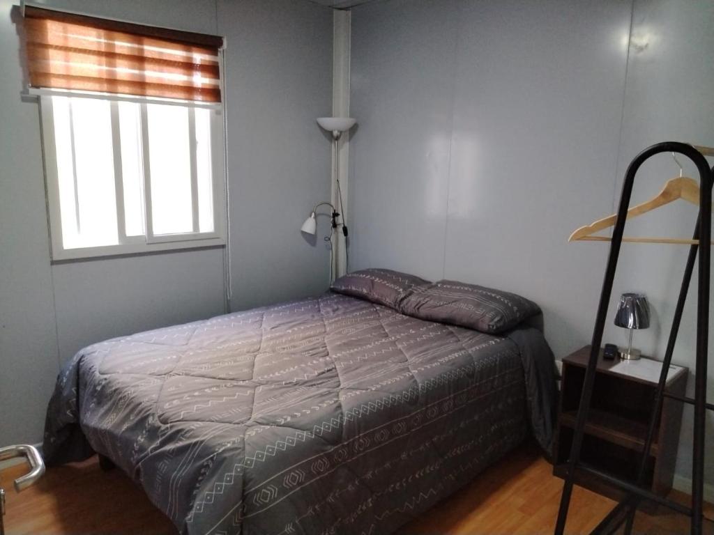 Un pat sau paturi într-o cameră la Hospedaje Oasis Modulares