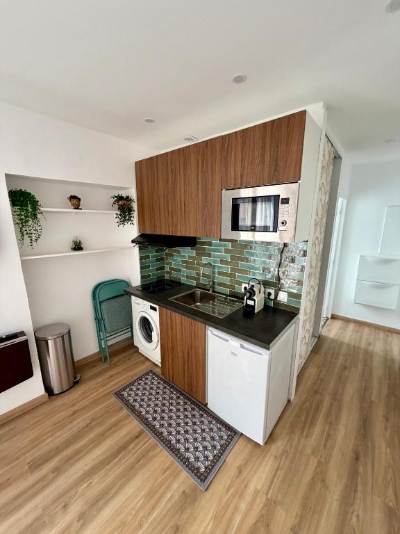 a kitchen with a sink and a stove at Hello sunshine nice in Nice