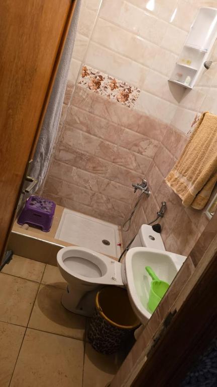 a bathroom with a toilet and a sink at Maison in Salé
