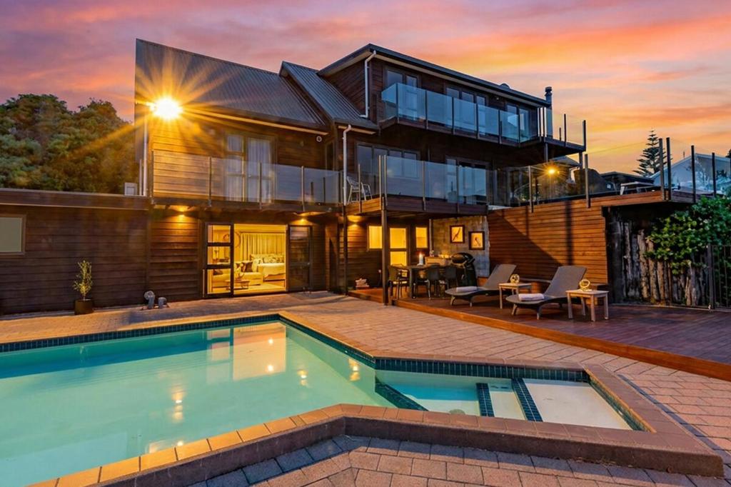 a house with a swimming pool in front of it at Hillside Haven in Whanganui