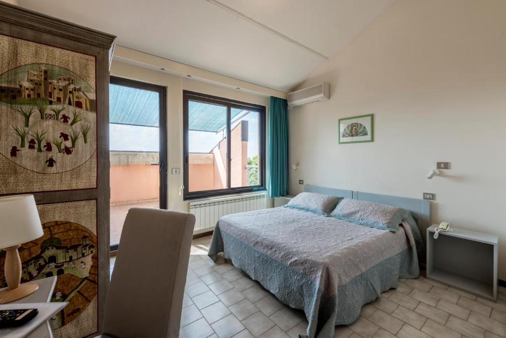 Postel nebo postele na pokoji v ubytování Hotel Le Tre Isole