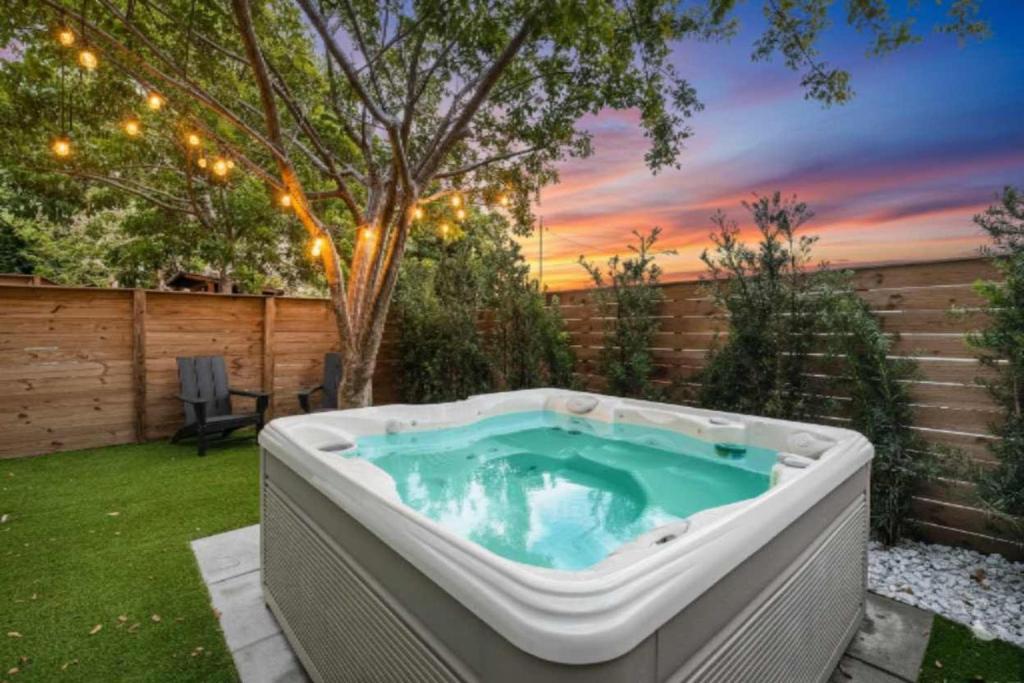 a hot tub in a backyard with a sunset at Luxury Home with Inter Miami Theme in Miami