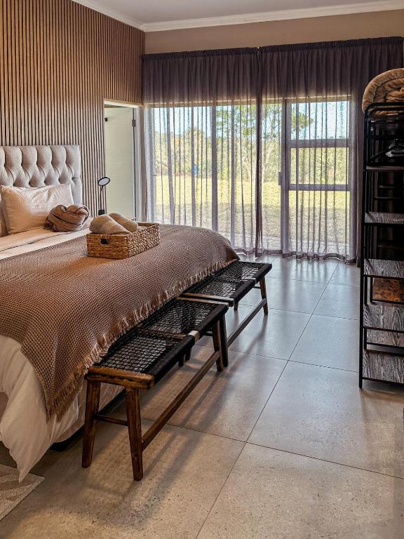 a bedroom with a large bed and a large window at Forestview Luxury Farm Stay in Bellcrest