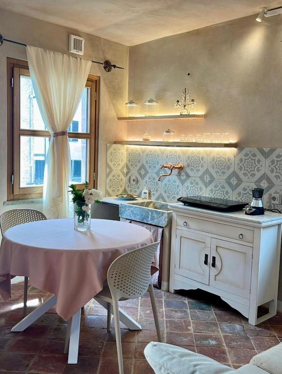 a kitchen with a table and a sink and a counter at La Casa di Paolo in Battifollo
