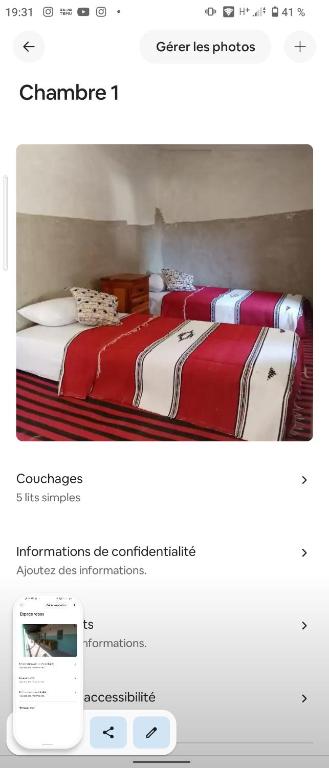 a bedroom with a bed with red and white sheets at Welcome home in Taounate