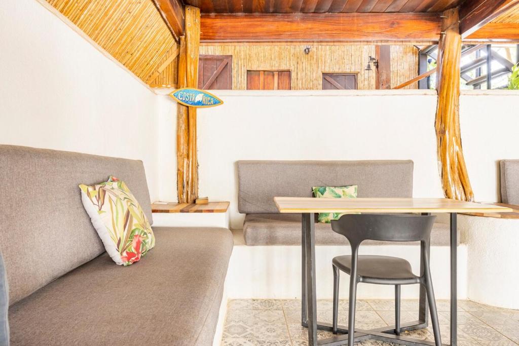 a table and two chairs in a room with a table at La Buena vida Cabina 1 in Playa Grande
