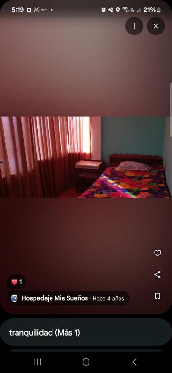 a picture of a bedroom with a bed with a window at Hospedaje Mis Sueños in San Antonio