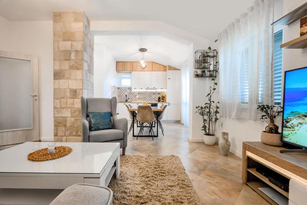 a living room with a tv and a table at Apartment MATEJA in Tivat